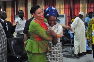 Bello Olabisi student from Dansol High School, Lagos, Winner of Children’s Essay Writing Competition at NAFEST 2016 in a warm embrace with Mrs. Dayo Keshi, DG National Council for Arts and Culture 