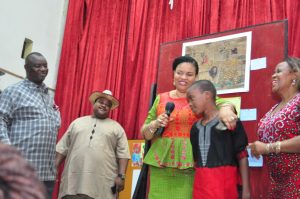 Abdulrahaman Saheed 13 years old student from Isolo Comprehensive High School, Lagos, Winner of Children’s Drawing/Painting Competition at NAFEST 2016 been congratulated by Mrs. Dayo Keshi, DG, National Council for Arts and Culture while the Hon. Commissioner of Culture and Tourism Akwa Ibom State Hon. Otuekong Ibiok looks on